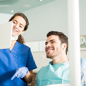 Dentist showing patient image on tablet