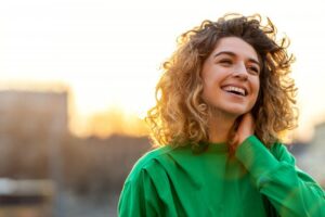 young woman smiling outside